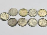 a close up of a bunch of coins sitting on top of a white surface