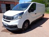 a white van parked in front of a building