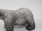 a small statue of a polar bear on a white surface