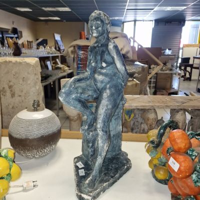 a statue of a woman sitting on top of a table