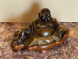 buddha figurine sitting on top of a marble counter top