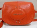 a close up of an orange handbag with the word longchamp on it