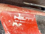 a close up of a red tool on a table