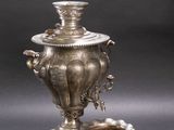 an antique silver plate with a silver cup and saucer on a tray