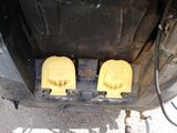two yellow pedals that are attached to the back of a truck