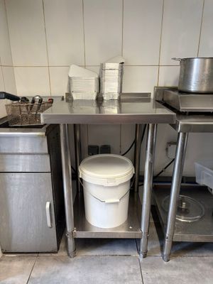 a kitchen with a sink, stove, and pots and pans