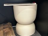 a toilet in the corner of a room with a box on the floor