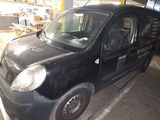 a small black car that is parked in a garage