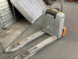 a forklift that is sitting in front of a garage door