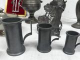 a lot of pewware sitting on a table