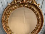 an image of a gold mirror sitting on top of a cardboard box
