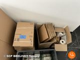many boxes of money sitting on the floor next to each other