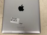 an apple ipad is sitting on a table with a price tag on it