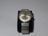 a silver watch with a black band on a white surface