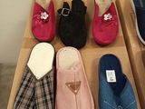 several pairs of slippers are lined up on a wooden shelf
