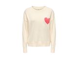 un pull blanc avec un cœur rose sur la poitrine