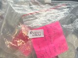 a bag of coins sitting on a table with a pink sticker on it