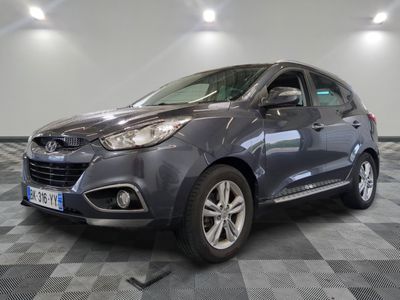 a picture of a grey car parked in a garage