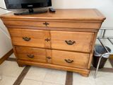 a television on top of a wooden dresser in a room