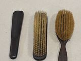 trois brosses et un peigne posés sur une table