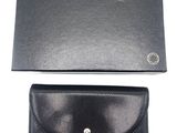a black leather wallet with a silver clasp and a black card case