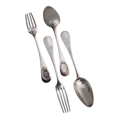 three spoons and two forks sitting next to each other