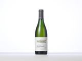 a bottle of white wine sitting on top of a table