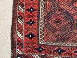 an old rug with a red and blue design on it