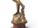 bronze figurine of a female golf player on a marble base