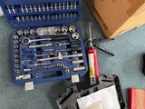 a tool kit that is sitting on the floor next to a box of tools