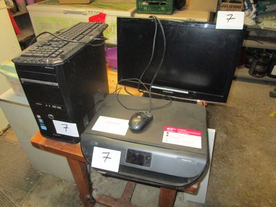two computers and a printer sitting on a table
