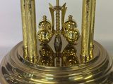 a gold clock that is sitting on top of a table