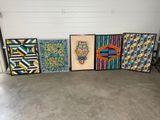 several paintings are lined up on a wall in a garage