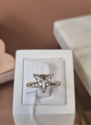 a white box with a ring in it on a table