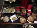 a display case with a lot of coins and other items