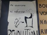 a sign on the table that says revolution and a sign that says boudre votre