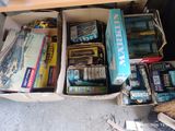 a lot of books and toys in a box on the floor