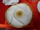 a white plate with a brown center sitting on a red table