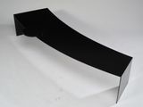 a black curved object on a white surface