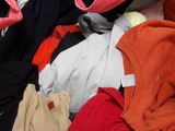 a pile of clothes that is sitting on the floor