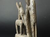an image of a sculpture of two people sitting on a bench