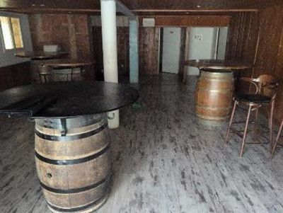 a room with a bar and several chairs in it