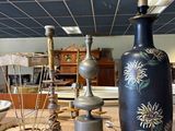 a table with a vase, lamp, and other items on it
