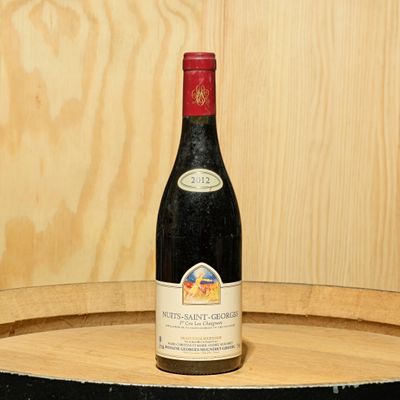 une bouteille de vin posée sur un tonneau en bois