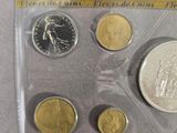 the coins are in a clear plastic case on the table