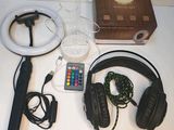 a table with headphones, a remote, a speaker, and a remote control