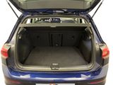 the back of a blue car with its trunk open showing the cargo compartment