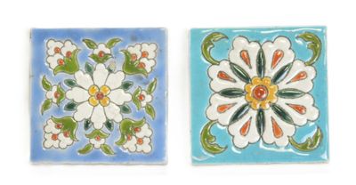 two tiles with flowers on them on a white background