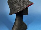 a close up of a hat on a mannequin head on a blue background