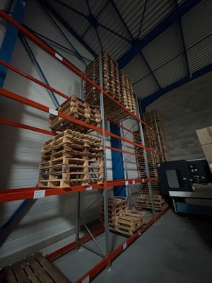 many pallets of wood stacked on the shelves in the warehouse